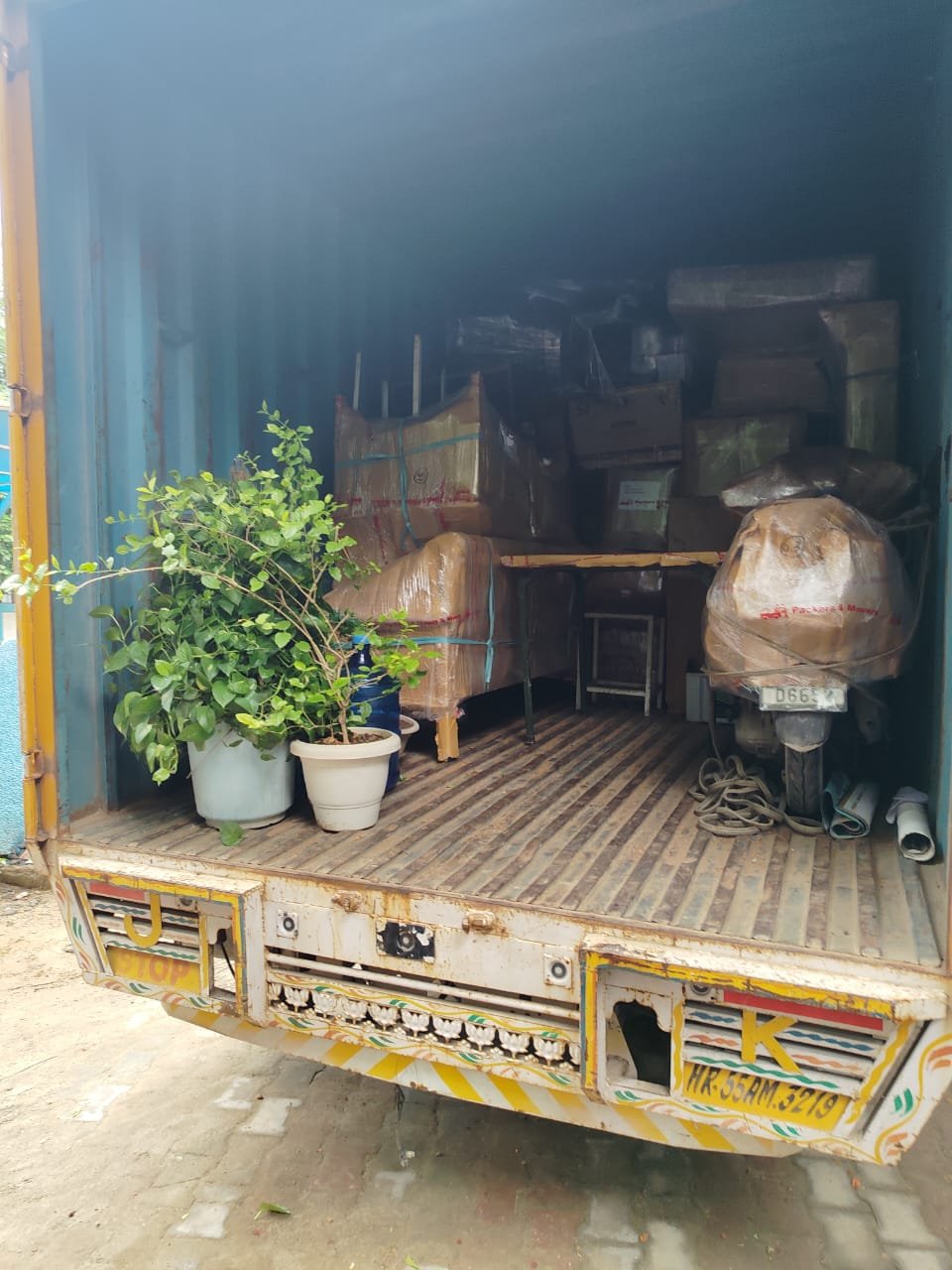 Household goods and plants carefully packed and loaded for a house shifting job