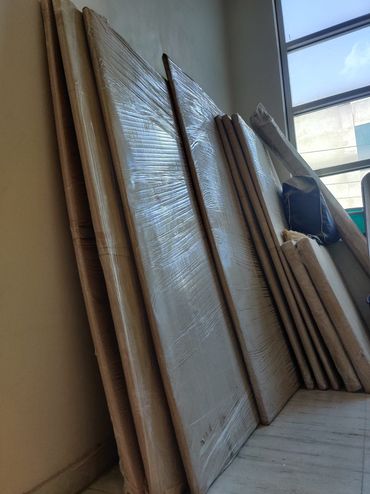 Mattresses and furniture panels wrapped in protective packing material