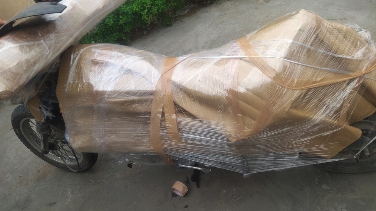 Scooter covered in corrugated cardboard and stretch wrap for shifting